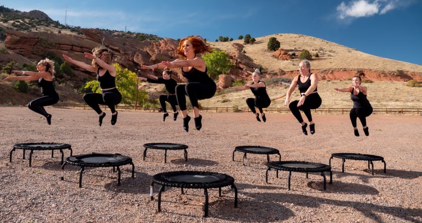 people sitting on black metal chairs on brown rocky mountain during daytime