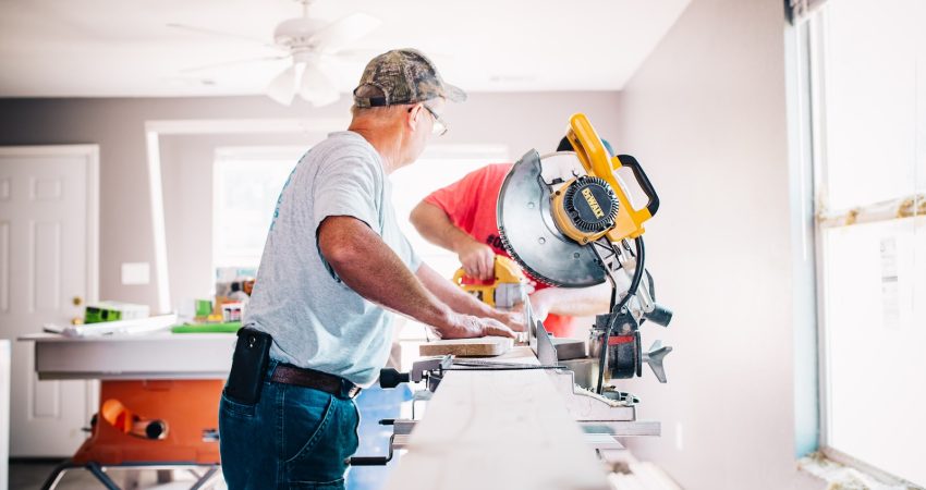 man standing infront of miter saw