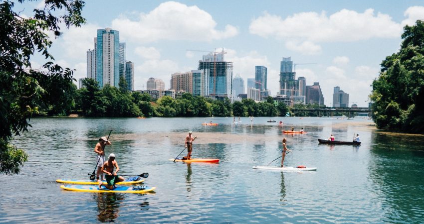 people riding paddle boards on the lake